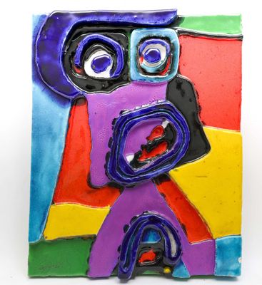 brightly colored ceramic sculpture of a face on a white background