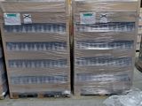 many boxes of water sitting on the floor in a warehouse