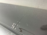 a close up of a car door with a small crack in it