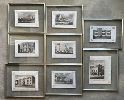 many pictures of old buildings displayed on the wall