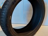 a close up of a tire on a white surface next to a wall