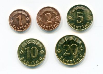 four different types of coins are shown on a white surface