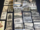 a table topped with lots of old black and white photos