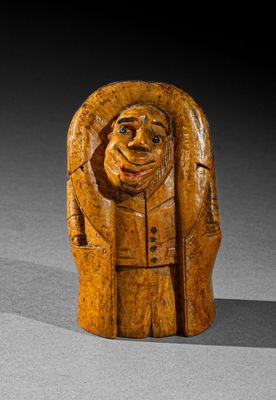 l'image d'une statue en bois représentant un homme coiffé d'un chapeau