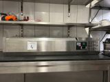 stainless steel counter top in a commercial kitchen with stainless steel shelvings