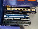 three toy trains sitting next to each other on a table