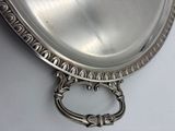 a silver plate with a handle on a white table