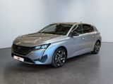 a silver car parked in a room with a white wall