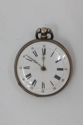 clock with roman numerals on the face of it hanging on a wall