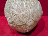 a vase that is sitting on a red cloth