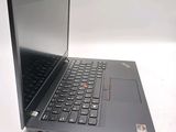 a laptop with a black keyboard on a white surface