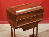 a small wooden table with a drawer on top of it