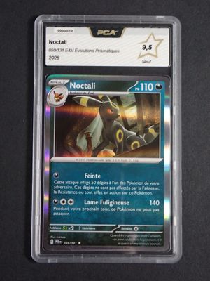 the card is in a plastic holder on a black surface