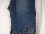 the jeans are hanging on a clothes rack on a white sheet