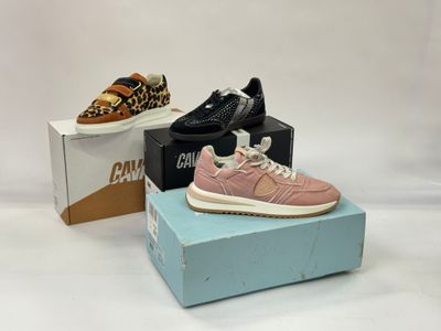 two pairs of shoes are on a box and one is pink and the other is leopard