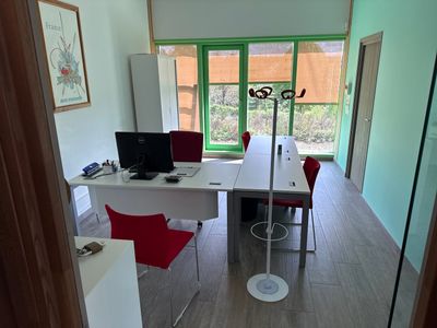 a room with a desk, chair, and a computer on it