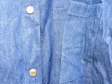 a close up of a blue shirt with buttons on it