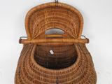 a wicker basket with a handle hanging from the wall
