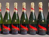six bottles of champagne are lined up in a row