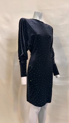 the mannequin is wearing a black dress with polka dots on it