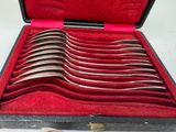several spoons are in a case with red velvet lining