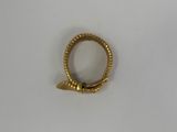 a close up of a gold ring on a white surface