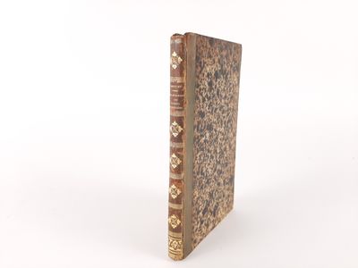 an old book that is sitting on a white surface