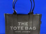 a black tote bag with the tote bag logo on it