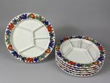 three plates with different designs on them sitting on a table