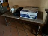 a table with a box on it and a coffee pot on it