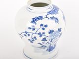 a blue and white vase sitting on a white surface
