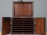 an old wooden box with a bunch of drawers inside of it