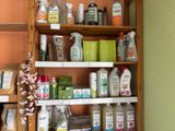 a wooden shelf with various cleaning products on it