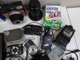 a table with a camera, a cell phone, a camera, a camera case, and other electronics