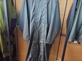 a green rain suit hanging on a rack in a store