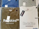 four t - shirts that are on display on a table