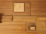 a close up of a wooden wall with a square and square blocks