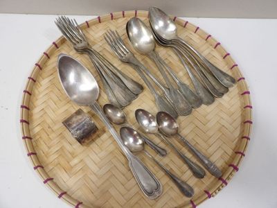 a plate with silverware on it and a spoon and spoon rest on the plate