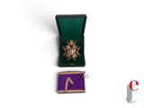 an image of a small medal and a purple ribbon on a white surface