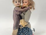 two dolls that are standing next to each other