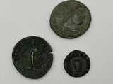 three ancient roman coins, one of which is a woman and one of which is a man
