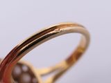a close up of a person holding a gold ring
