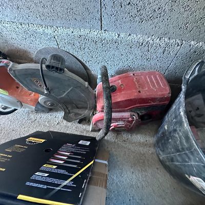 a box of tools sitting on the floor next to a box of tools