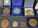 several medals and medals are in a blue box on a table