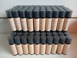 a lot of bottles of makeup sitting on a table