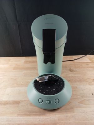 a cup that is sitting on a table with a phone in it