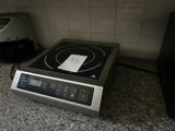 a black and silver stove top on a granite counter top