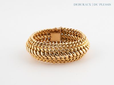 an image of a close up of a gold ring on a white surface