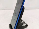 a cell phone that is on a stand on a table