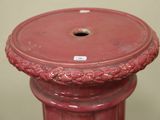 a red vase that has a red lid on it